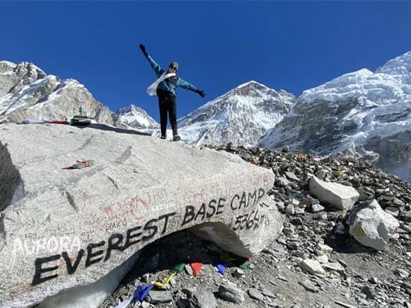 Trekker standing on the iconic rock at Everest Base Camp - 17,270 feet