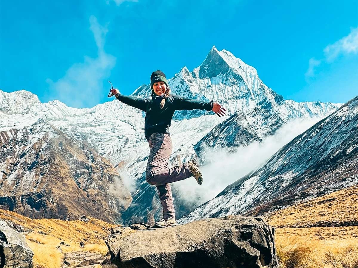 Beautiful view of Mt. Fishtail from Annapurna Base Camp; Trekker enjoying the moment
