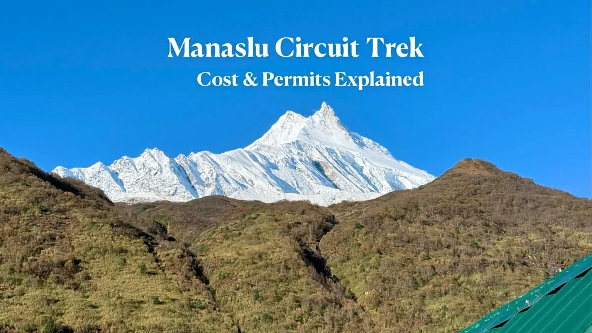 Panoramic view of Manaslu mountains with prayer flags fluttering in the high-altitude winds.