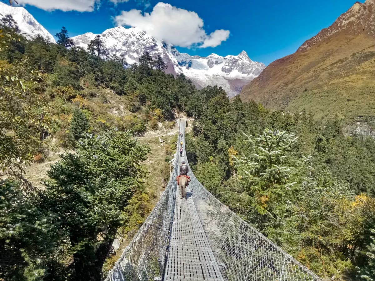 Crossing suspension bridge on the Manaslu Circuit Trail
