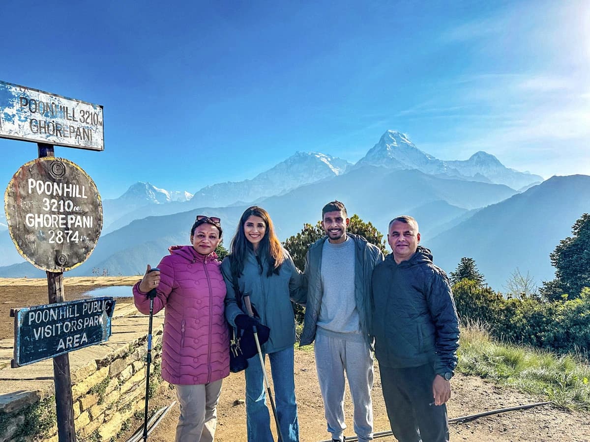 People standing at Poonhill and Annapurna Mountain range in the background