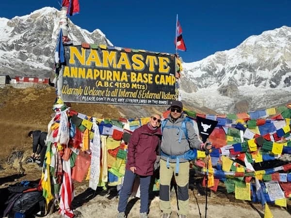 Trekkers at Annapurna Base Camp surrounded by the Himalayan peaks