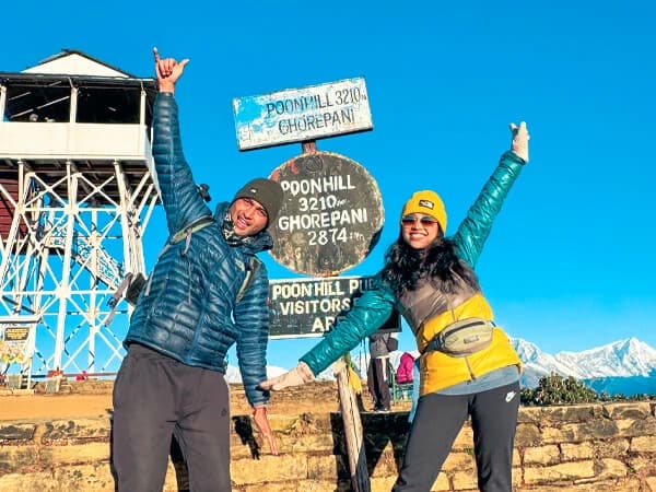 Trekker standing with guide at Poonhill