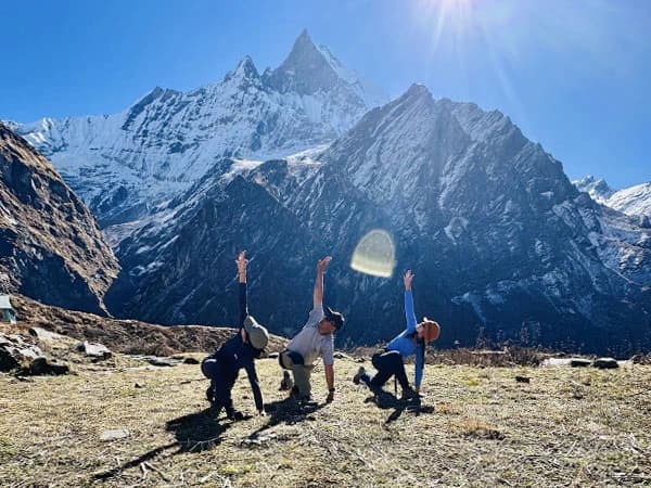 Performing Yoga Stretches in front of Mount. Fishtail during Annapurna Base Camp Trek